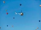 Photos aériennes de "ciel" - Photo réf. E145960 - L'hlicoptre de l'Europe vue du ciel en plein travail de prises de vues ariennes autour des montgolfires du Mondial Air Ballons 2013.