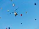 Photos aériennes de "ciel" - Photo réf. E145963 - L'hlicoptre de l'Europe vue du ciel en plein travail de prises de vues ariennes autour des montgolfires du Mondial Air Ballons 2013.